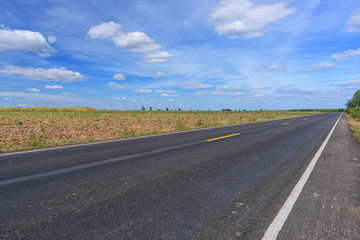 Asphalt road and landscape countryside with blue sky.