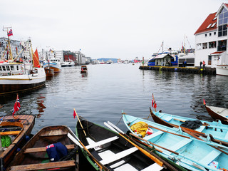 Fototapeta na wymiar Bergen harbour in Norway. Boats with nowegian flags. 