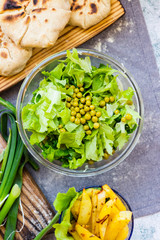Green herbal leaves fresh detox salad in glass bowl. Vegan, vegetarian healthy diet food