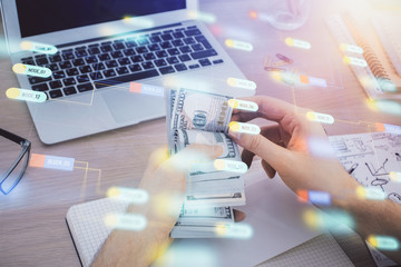 Multi exposure of technology drawing hologram and us dollars bills and man hands. Data concept