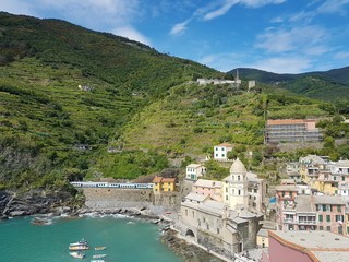 Fototapeta na wymiar Italy, Cinque Terre, Vernazza. Beautiful view of a coast line with greenery, turquoise sea and rocks