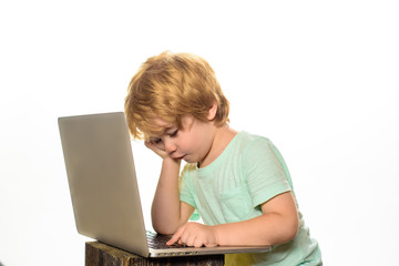 Distance Learning. Boy with notebook. Online homework. Modern technology. Little boy with laptop at home. Internet, homework and social media. Cute kid playing computer at home. Learning concept.