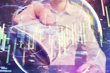 Multi exposure of financial theme drawing hologram and USA dollars bills and man hands. Business concept.