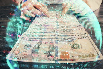 Multi exposure of financial theme drawing hologram and USA dollars bills and man hands. Business concept.