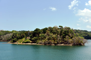 Green landscape of Panama Canal, view from the transiting cargo ship.