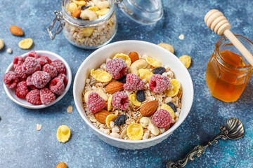 Healthy breakfast. Fresh granola, muesli with nuts and frozen berries. Top view. Copy space.