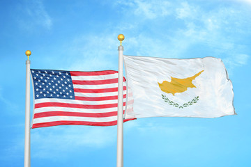 United States and Cyprus two flags on flagpoles and blue cloudy sky