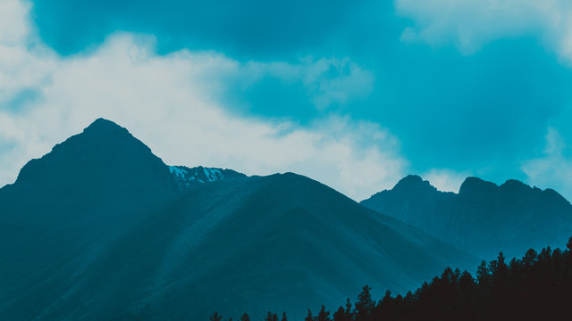 high cliffs in blue haze, silhouette of mountain range in fog, meditation and relaxation in nature