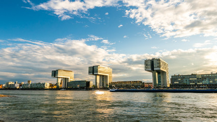 Panorama of crane houses by the Rhine under the blue sky and white clouds. Cityscape on sunny day