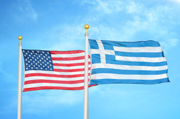 United States and Greece two flags on flagpoles and blue cloudy sky