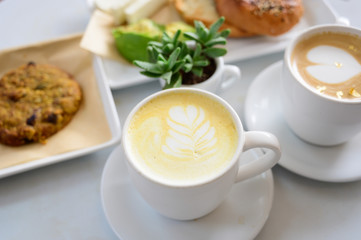 Cafe Latte table set with breakfast and green plant