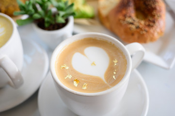 Cafe Latte table set with breakfast and green plant