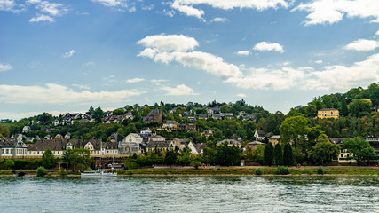 Fototapeta na wymiar Landscape by the Rhine in Koblenz of Germany; buildings near Festung Ehrenbreitstein under blue sky and white clouds 