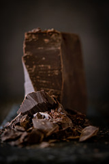 Chunks of dark chocolate with dark background