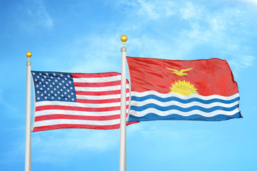 United States and Kiribati two flags on flagpoles and blue cloudy sky