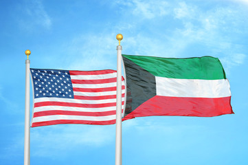 United States and Kuwait two flags on flagpoles and blue cloudy sky