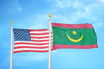 United States and Mauritania two flags on flagpoles and blue cloudy sky