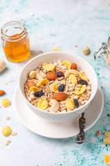 Healthy breakfast. Fresh granola, muesli with nuts and frozen berries. Top view. Copy space.