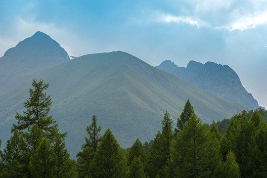 high cliffs in blue haze, silhouette of mountain range in fog, meditation and relaxation in nature