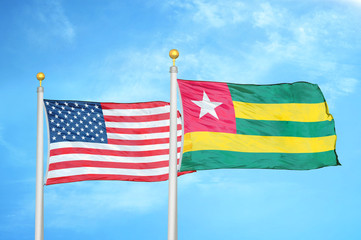 United States and Togo two flags on flagpoles and blue cloudy sky