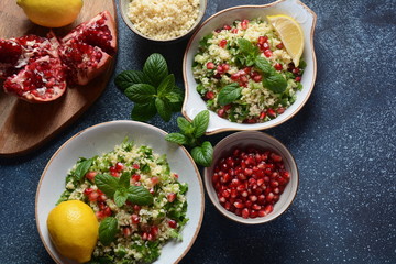 Healthy salad with couscous, fresh mint, cucumber, pomegranate, lemon and olive oil. Eastern cuisine. Vegan food concept. Traditional Israeli food