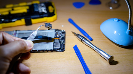 Repairing the chip of smartphone  motherboard in the lab. Cell phone repair parts and tools for recovery.16:9 style