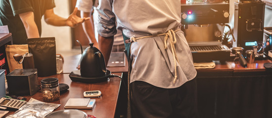 The back view of the barista in the bar counter at the coffee shop. Coffee, Barista, Bar, Cafe,...