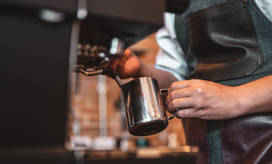 Close-up of professionally extracting coffee by barista with a pouring steamed milk into coffee cup making beautiful latte art. coffee, extraction, deep, cup, art, barista concept. - obrazy, fototapety, plakaty