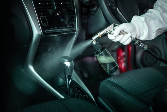 Clean surfaces in car with a disinfectant spray. Help kill coronavirus in  car after going out.