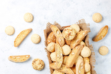 Various cookies in a wooden tray on gray background