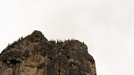 rock cliff against sky. Travel in mountains, stone wall for mountaineering