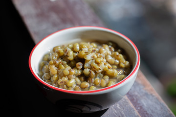 Boiled green beans in a cup, placed by the window.
