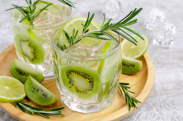 Transparent drink with fruit and rosemary