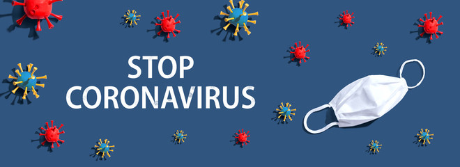 Stop Coronavirus theme with virus and a white mask - flat lay