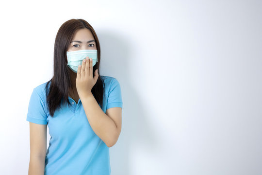 Asian Women Wear Masks To Prevent Disease Covid 19, Long Haired-black Women. Wearing A Blue Collar Shirt. Woman Covering Her Mouth On White Background.