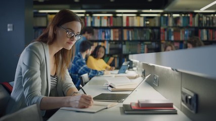 University Library: Talented Caucasian Girl uses Laptop, Smart Helpful Classmate Explains and Advices Her with Class Assignment. Happy Diverse Students Talking, Learning, Studying Together for Exams - Powered by Adobe