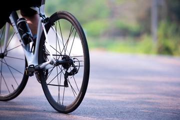 Fototapeta premium Sports. Asian cyclists ride bicycles on the open road to sunset.