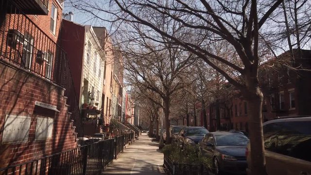 Empty street with colorful buildings in Cobble Hill Brooklyn New york. Daytime. Wide shot with subtle camera motion.