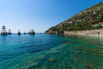 Alanya. Turkey. Shipyard (Tersane) and the ruins of a medieval fortress (Alanya Castle) on the mountainside.