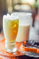 milk in glass on wood table at cafe .Delicious homemade