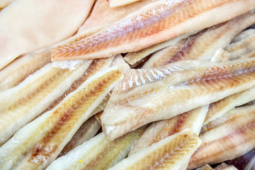 Many pieces of cod fillet. Fresh frozen sea fish.