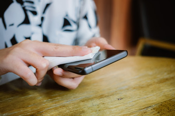 clean smartphone with cotton pad and alcohol for protect bacteria and virus