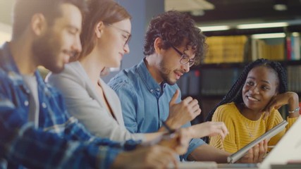 Diverse Team of Young Brilliant Entrepreneurs and Office Specialists Have a Meeting, Talking, Using Digital Tablet Computer, Finding Solutions and Solving Problems. Talented Young People Working - Powered by Adobe