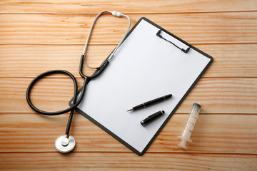 stethoscope and notebook on table