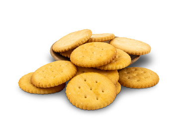 Pile of round crackers and wooden plate on white background with clipping path