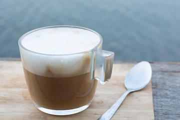 Coffee cup placed on wooden table.