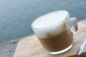 Coffee cup placed on wooden table.