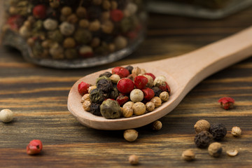 Assortment of colorful spices in the wooden spoon , close up