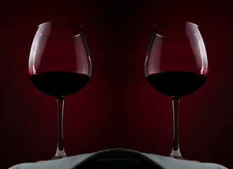 two glass of french wine on a red background.
