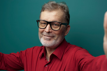 Obraz premium Close-up portrait of positive elderly handsome man